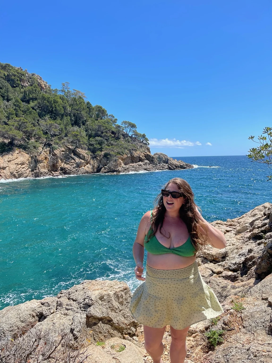 Taylor by a bright blue coastal cove