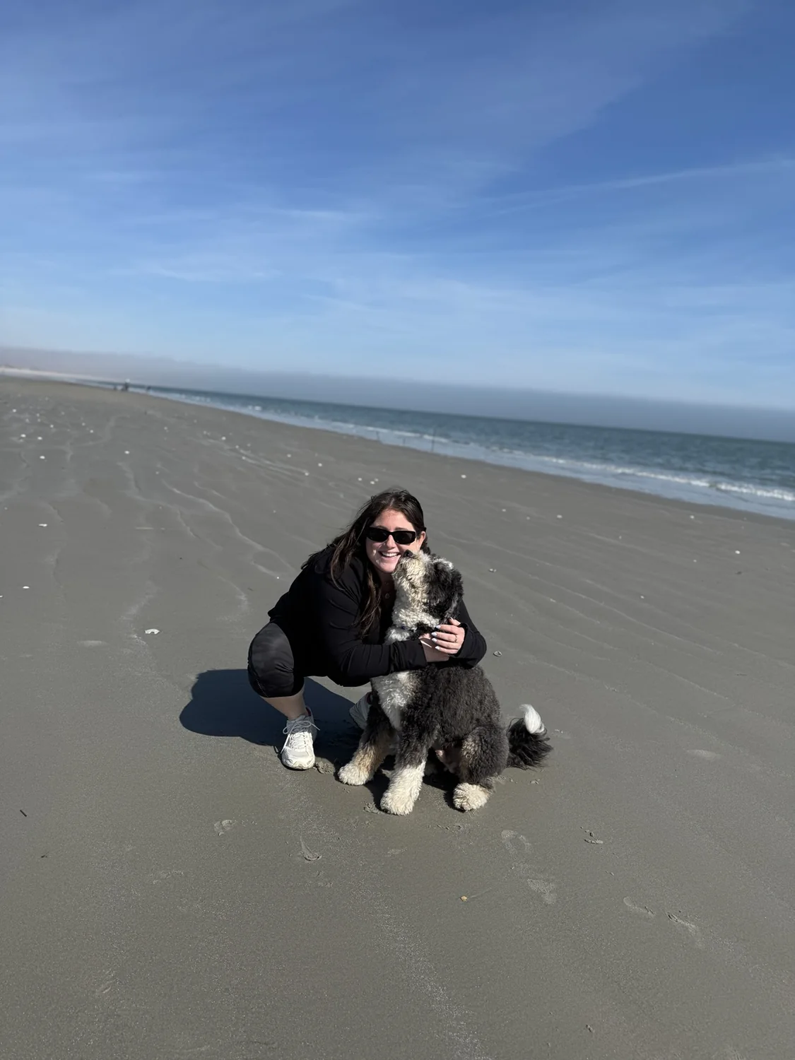 Taylor with her dog on the beach